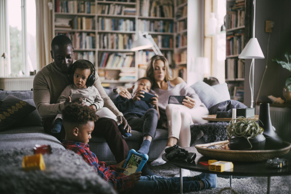 A family on their devices in the living room