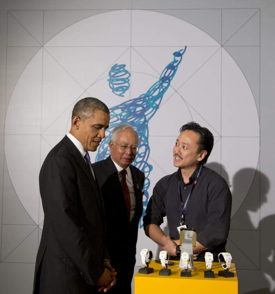 U.S. President Barack Obama and Malaysian Prime Minister Najib Razak, center, are greeted by Geoffrey Tan, the creator of the Hypoband, which is designed for use by diabetics and can detect a cold sweat and warn others of the user’s need for help as they visit the Malaysian Global Innovation and Creativity Centre in Cyberjaya, Malaysia, Sunday, April 27, 2014. The last American president to visit Malaysia was Lyndon B. Johnson in 1966. (AP Photo/Carolyn Kaster)