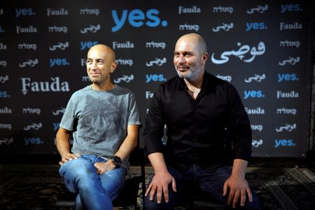 Avi Issacharoff and Lior Raz, showrunners of Israeli television series "Fauda" smile during their interview with Reuters in Tel Aviv