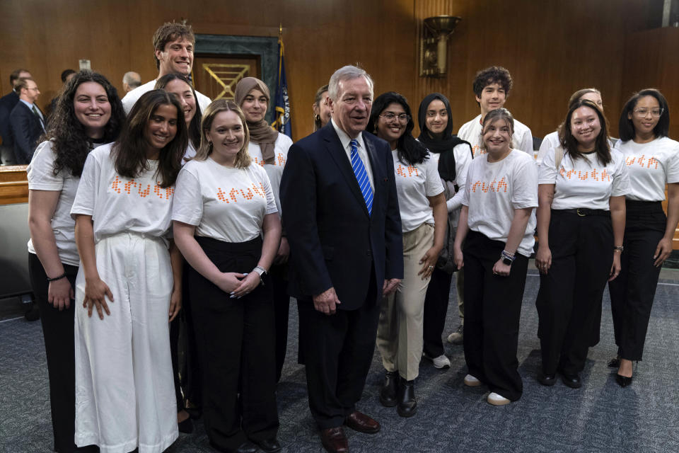 Senate Judiciary Committee Chairman Sen. Dick Durbin, D-Ill., poses for a photograph with a group of students against vaping after a hearing on combating the rise of illegal electronic cigarettes, on Capitol Hill, Wednesday, June 12, 2024, in Washington.( AP Photo/Jose Luis Magana)