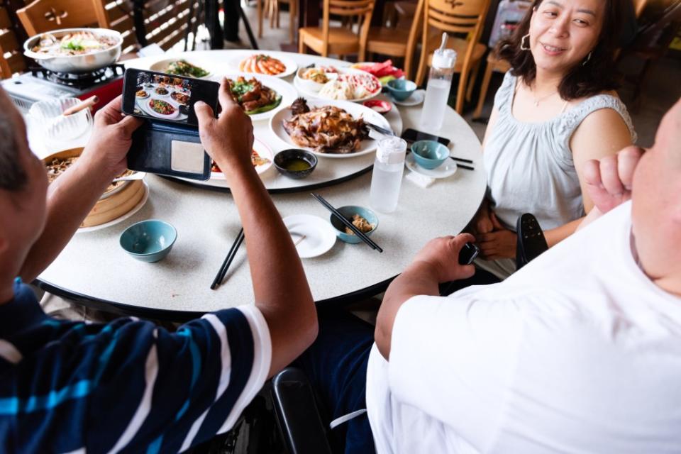 We live in a culture in which phones “eat first” — meaning snapshots of prepared plates must be taken before anyone can dig in. Getty Images