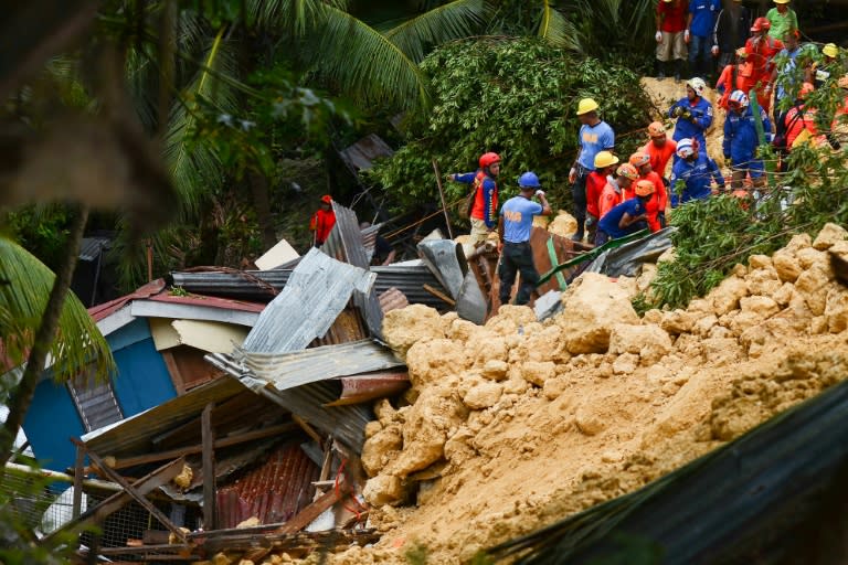 Rescuers search for survivors at the site of a landslide in Naga City, on the popular tourist island of Cebu