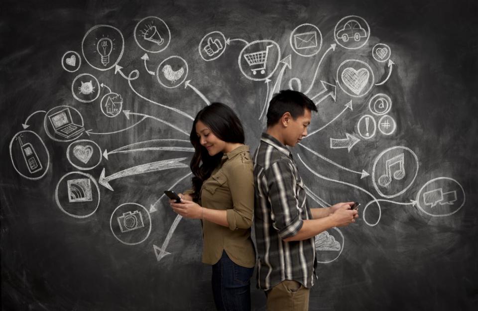 People on phones with social media icon chalkboard