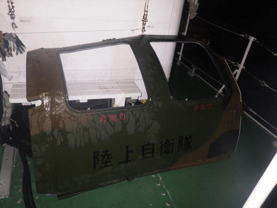An unidentified object which was floating in the ocean near the site of a military helicopter that crashed in the sea is seen on a ship after it was recovered from the sea near Miyakojima, Okinawa Prefecture, Japan, in this handout photo taken on April 7, 2023. 11th Regional Coast Guard Headquarters-Japan Coast Guard/HANDOUT via REUTERS ATTENTION EDITORS - THIS IMAGE WAS PROVIDED BY A THIRD PARTY.  MANDATORY CREDIT. BEST?QUALITY?AVAILABLE