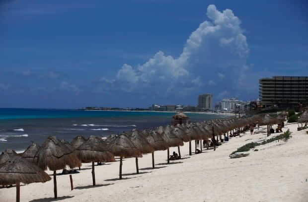 Tourists relax on a beach in Cancun, Mexico, last month. Several airlines in Canad with routes south say the fall and winter seasons are looking promising. (Marco Ugarte/The Associated Press - image credit)