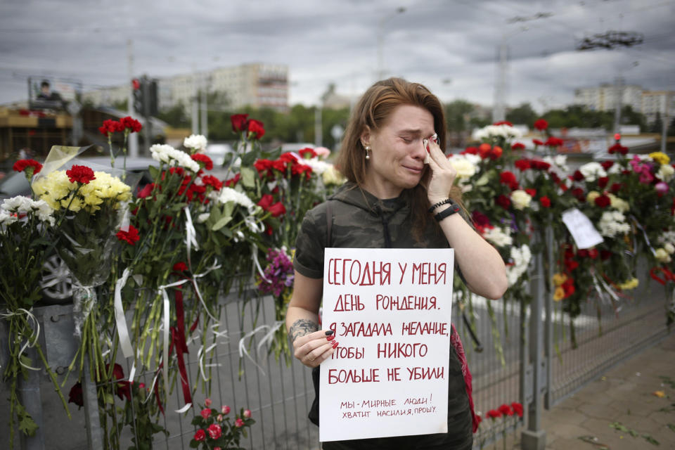 Alina Krus, 26, holds a poster at the place where a protester died amid the clashes in Minsk, Belarus, Wednesday, Aug. 12, 2020 saying "It's my birthday today. I made a wish that no one gets killed. We are peaceful people. Enough with the violence, please." Krus says it is her first time protesting in the street -- she couldn't stay home and celebrate her birthday while so many people she knows got detained. (AP Photo)