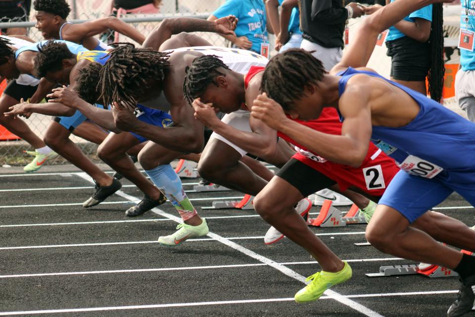 Runners break from the blocks during a preliminary heat of the boys 100-meter dash at the Bob Hayes Invitational Track Meet on March 19 at Raines.