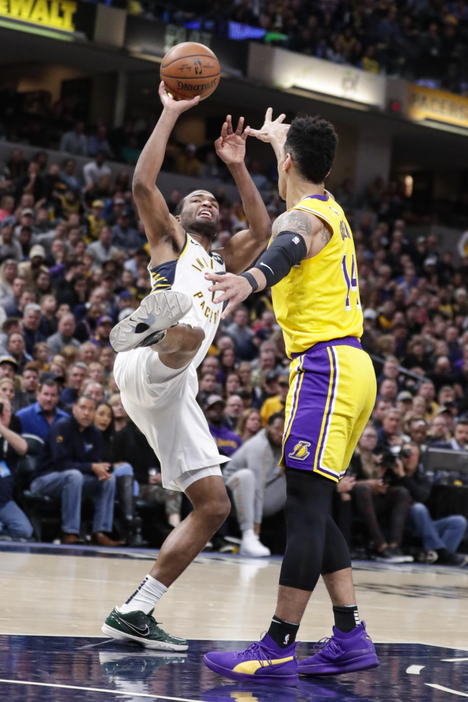 Indiana Pacers forward T.J. Warren (1) shoots over Los Angeles Lakers guard Danny Green (14) during the second half of an NBA basketball game in Indianapolis, Tuesday, Dec. 17, 2019. The Pacers defeated the Lakers 105-102. (AP Photo/Michael Conroy)