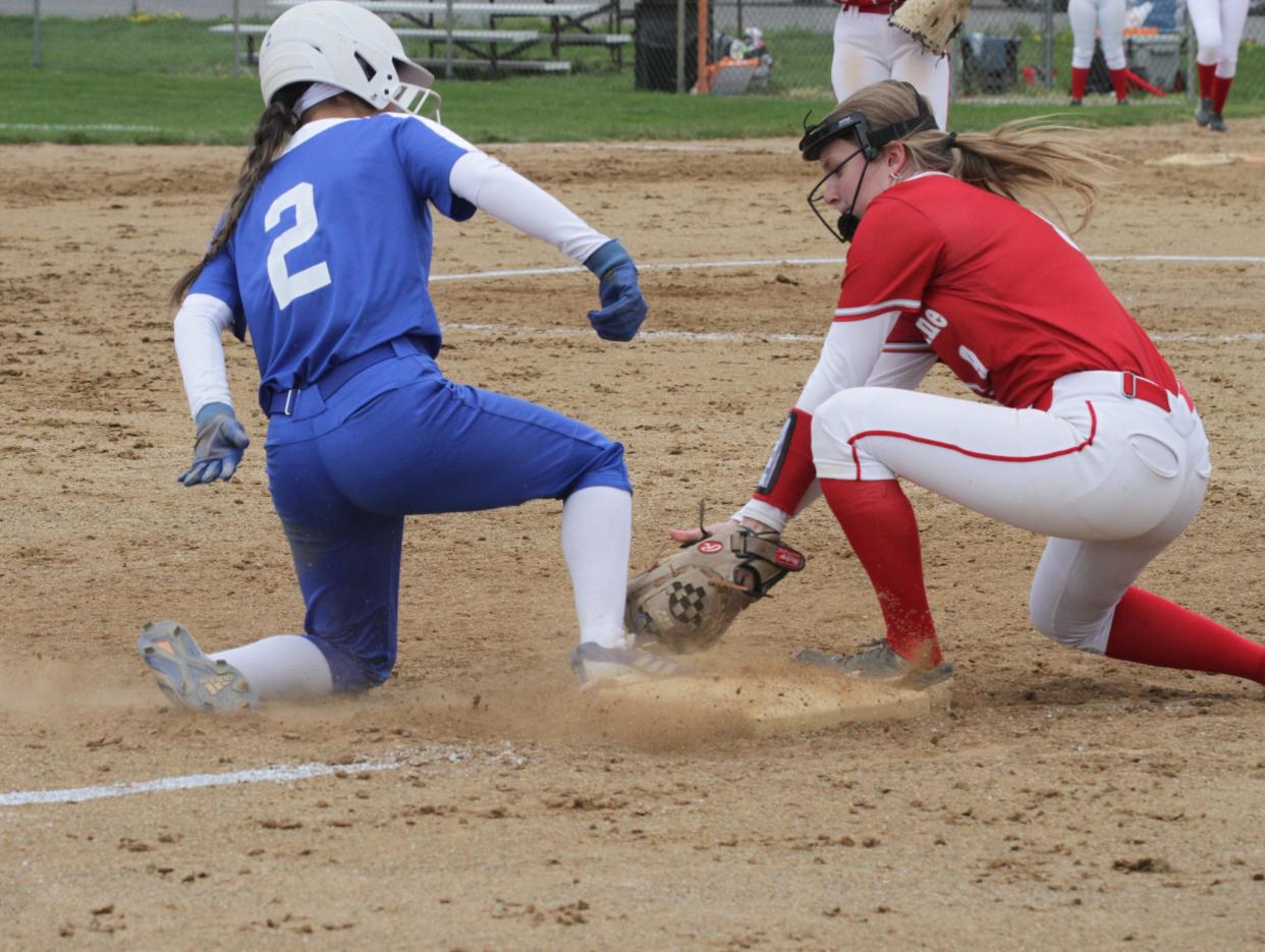 Burr Oak's Braylyn Hernandez is safe at third base before the tag from Constantine's Felicity Cheeks.