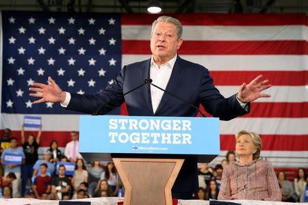 Former Vice President Al Gore talks about climate change (L) as U.S. Democratic presidential nominee Hillary Clinton listens at a rally at Miami Dade College in Miami, Florida, U.S. October 11, 2016. REUTERS/Lucy Nicholson