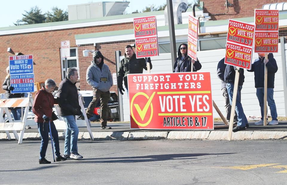 Hampton firefighters engage with voters at Winnacunnet High School, advocating for support on Articles 16 and 17 during the March 12, 2024, Town Meeting.