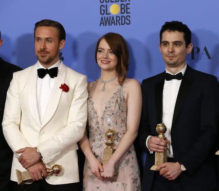 Ryan Gosling (L), Emma Stone and Damian Chazelle pose together after "La La Land" won the award for Best Motion Picture - Musical or Comedy, as well as individual awards for Best Performance by an Actor in a Motion Picture - Musical or Comedy for Gosling, Best Performance by an Actress in a Motion Picture - Musical or Comedy for Stone and Best Director - Motion Picture for Chazelle, during the 74th Annual Golden Globe Awards in Beverly Hills, California, U.S., January 8, 2017. REUTERS/Mario Anzuoni