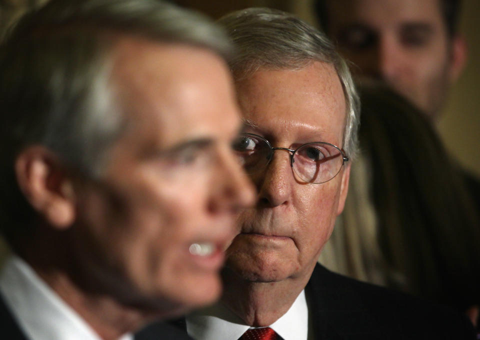 Senate Majority Leader Sen. Mitch McConnell listens as Sen. Rob Portman (L) speaks during a media briefing after the Senate Republican weekly policy luncheon at the U.S. Capitol. (Photo: Alex Wong via Getty Images)