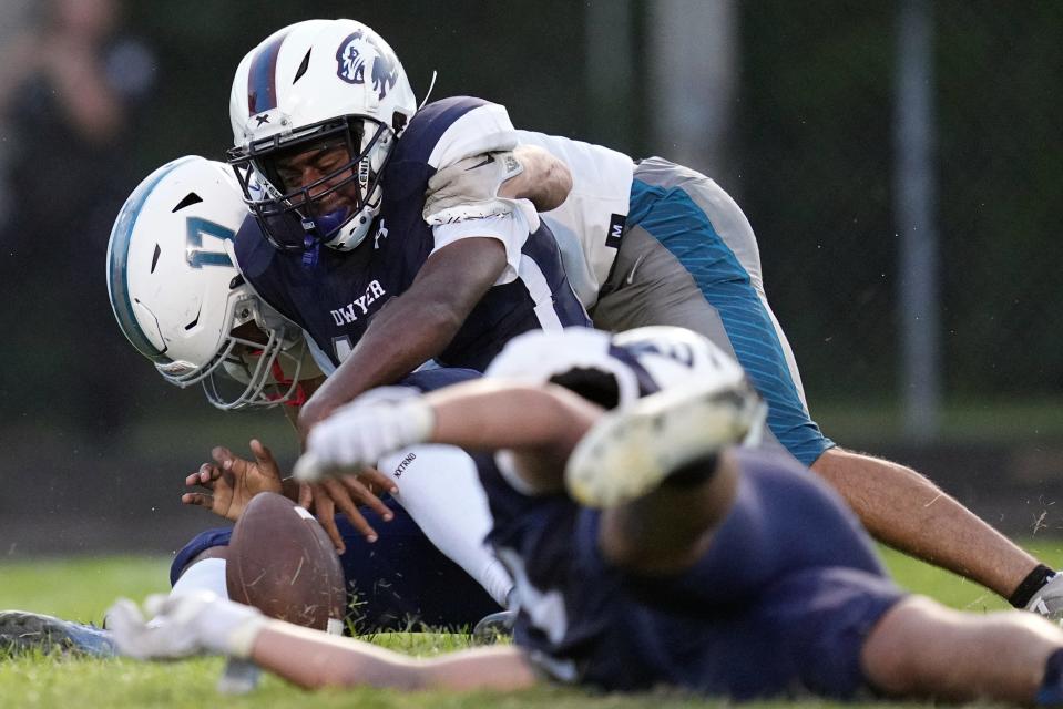 Carlos McCormack (17) of Jensen Beach High causes a fumble by Dwyer High quarterback Shy Deveaux (16) in the first half on Friday, September 1, 2022 in Palm Beach Gardens.