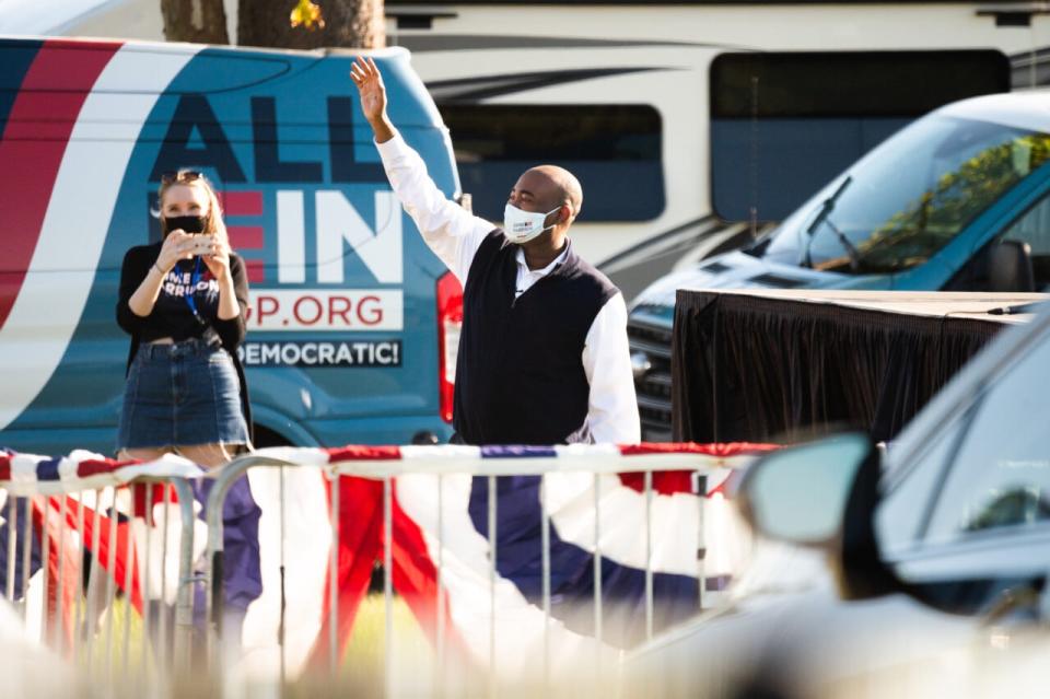 Democratic Senate candidate Jaime Harrison waves to supporters before speaking at a drive-in rally on October 17, 2020 in North Charleston, South Carolina. Harrison is running against incumbent Sen. Lindsey Graham (R-SC). (Photo by Cameron Pollack/Getty Images)