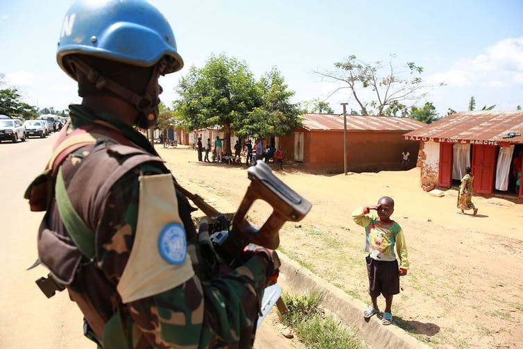 <span class="caption">A Congolese child saluting a MONUSCO peacekeeper.</span> <span class="attribution"><a class="link " href="https://commons.wikimedia.org/w/index.php?curid=37421171" rel="nofollow noopener" target="_blank" data-ylk="slk:Abel Kavanagh/Wikimedia Commons;elm:context_link;itc:0;sec:content-canvas">Abel Kavanagh/Wikimedia Commons</a>, <a class="link " href="http://creativecommons.org/licenses/by-sa/4.0/" rel="nofollow noopener" target="_blank" data-ylk="slk:CC BY-SA;elm:context_link;itc:0;sec:content-canvas">CC BY-SA</a></span>