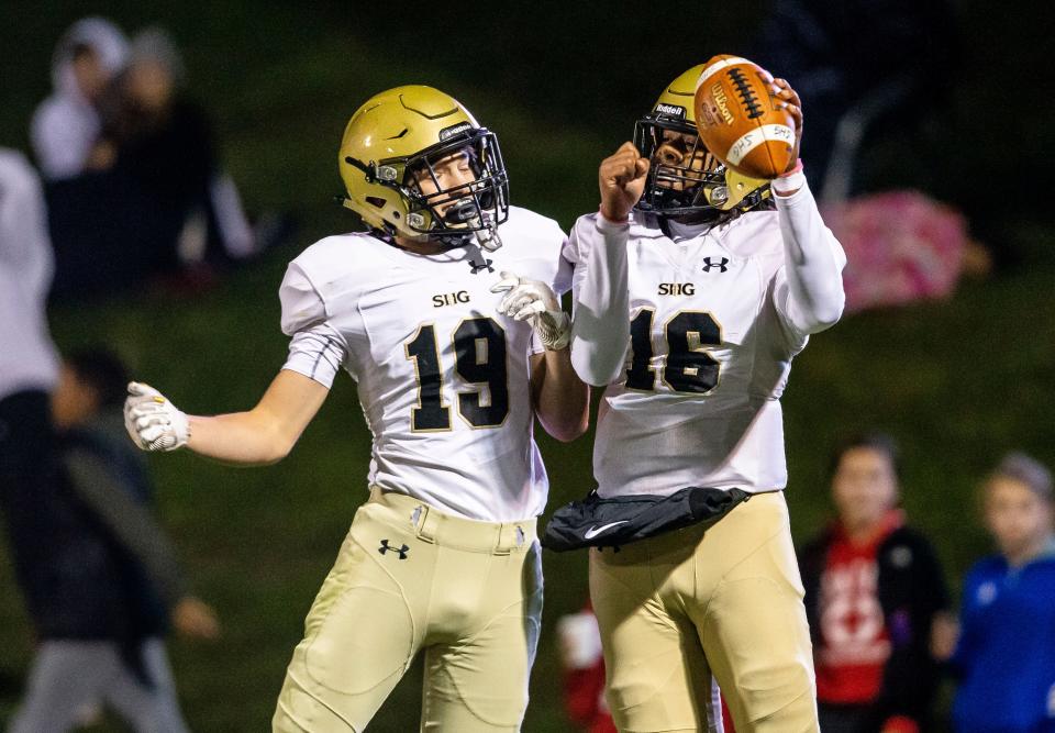 Sacred Heart-Griffin quarterback Ty Lott (16) celebrates his touchdown with Sacred Heart-Griffin's Kyle Long (19) against Glenwood in the first half at Glenwood High School in Chatham, Ill., Friday, October 22, 2021. [Justin L. Fowler/The State Journal-Register] 