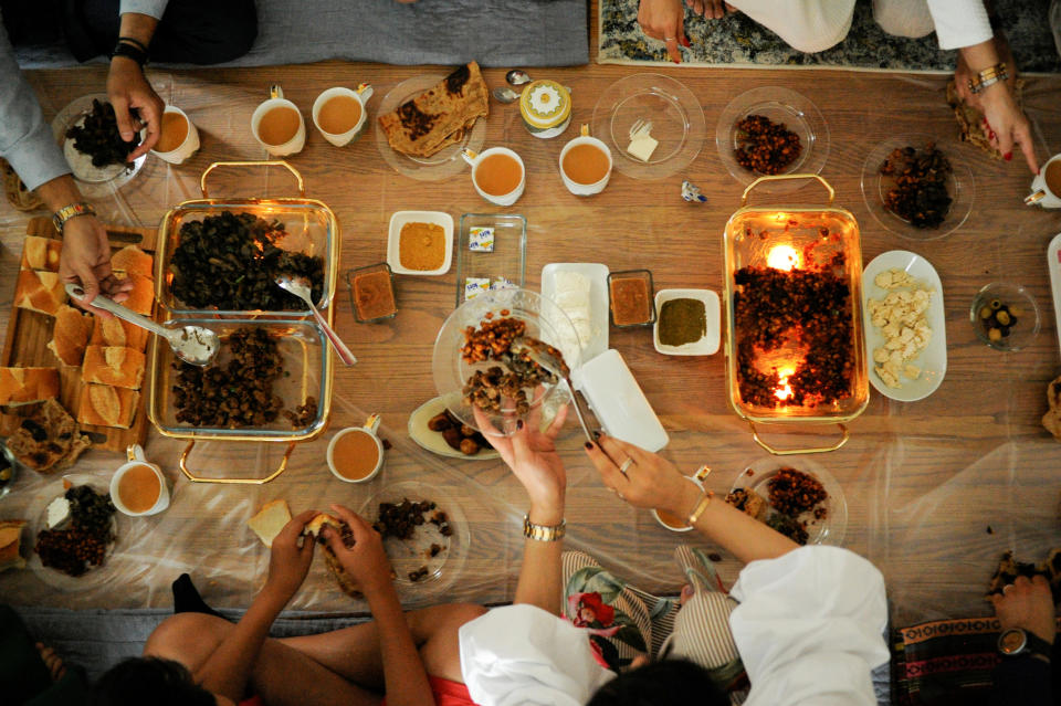 The Yemeni-American Muslim Udayni family gather around for a large Eid breakfast, made up of traditional Yemeni dishes, to celebrate Eid al-Fitr holiday in Brooklyn, New York, U.S., on June 25, 2017.&nbsp;