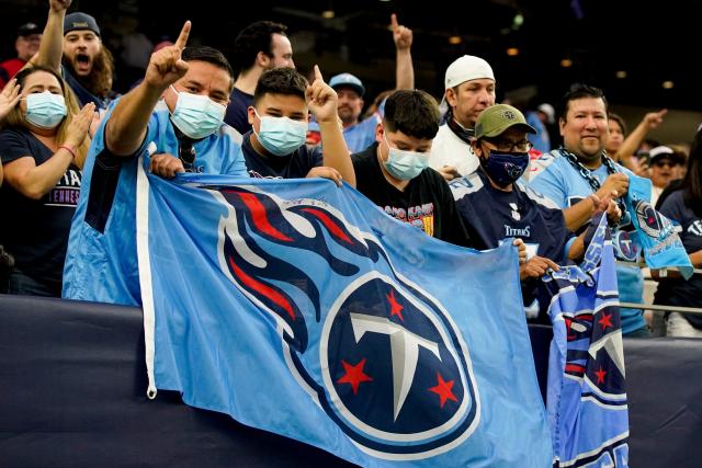 Tennessee Titans vs. Indianapolis Colts. Fans support on NFL Game.  Silhouette of supporters, big screen with two rivals in background. Stock  Photo