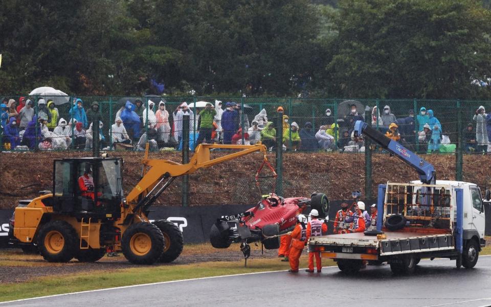 The car of Carlos Sainz of Spain and Ferrari is recovered from the track after a crash during the F1 Grand Prix of Japan at Suzuka International Racing Course on October 09, 2022 in Suzuka, Japan - Getty Images