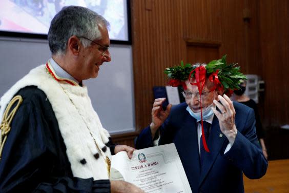 Paterno is awarded his graduation certificate (Reuters/Guglielmo Mangiapane)