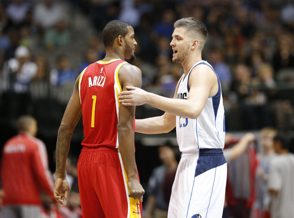 Oct 7, 2014; Dallas, TX, USA; Dallas Mavericks forward Chandler Parsons (25) hugs Houston Rockets forward Trevor Ariza (1) prior to the game at American Airlines Center. (Matthew Emmons-USA TODAY Sports)