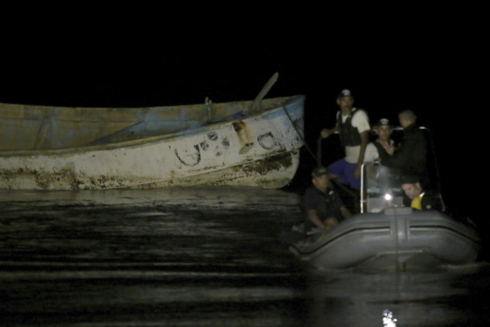 Police move a boat that was carrying corpses to the Vila do Castelo port in Braganca, Brazil, early Monday, April 15, 2024. Security forces and forensics were dispatched to the area after fishermen reported on Saturday spotting a boat with decomposing corpses off the coast of Para state. (AP Photo/Raimundo Pacco)