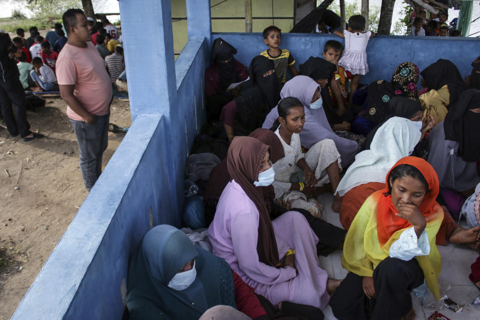 FILE - Newly-arrived ethnic Rohingya women, part of a group who was denied landing a few times by local residents, rest at a temporary shelter in Bireun, Aceh province, Indonesia on Nov. 20, 2023. The U.N. refugee agency on Monday Dec. 4, 2023 sounded the alarm for about 400 Rohingya Muslims believed to be aboard two boats reported to be out of supplies and adrift on the Andaman Sea. Hundreds more arrived in Aceh last month. There is a seasonal exodus of Rohingyas, usually coming from overcrowded refugee camps in Bangladesh. (AP Photo/Rafka Zaidan, File)
