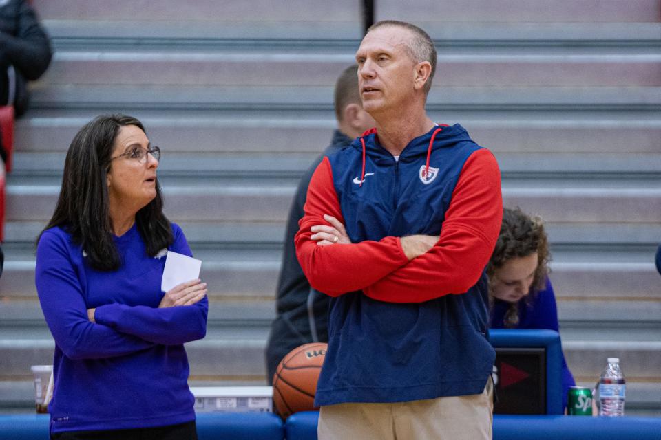 Plainfield Quakers head coach Curt Benge (Right) talks with Brownsburg Bulldogs head coach Debbie Guckenberger during pregame warmup Jan 5, 2024, at Plainfield High School in Plainfield, Indiana.