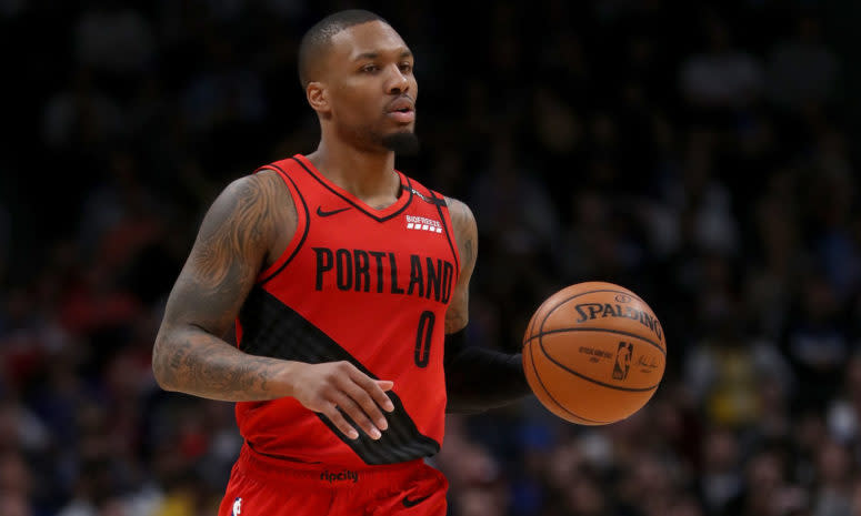 Damian Lillard dribbling the ball during a game against the Denver Nuggets in 2019.