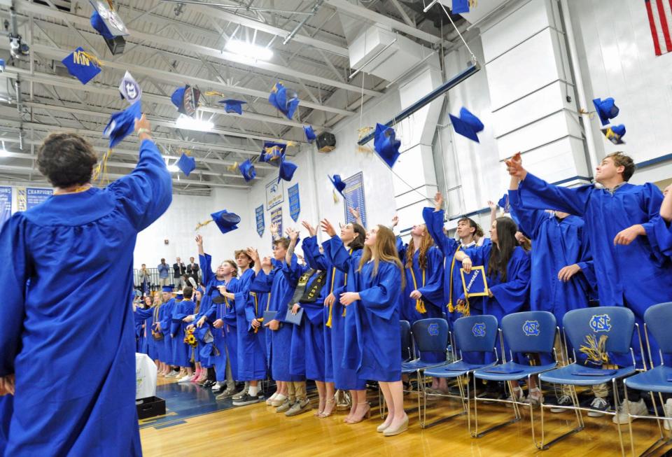 Graduates toss their caps during Norwell High School's graduation on Saturday, June 3, 2023.