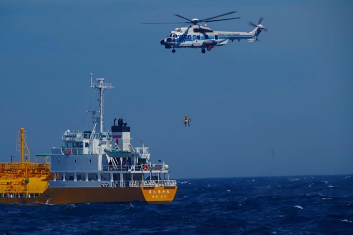 The woman is airlifted by a coast guard helicopter on 10 July 2024 (AP)