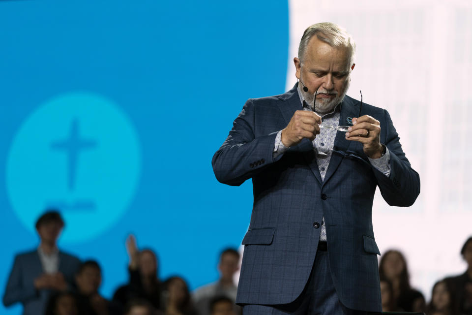 Pastor Ed Litton, president of the Southern Baptist Convention, takes off his glasses while singing during a worship service at its annual meeting in Anaheim, Calif., Tuesday, June 14, 2022. (AP Photo/Jae C. Hong)