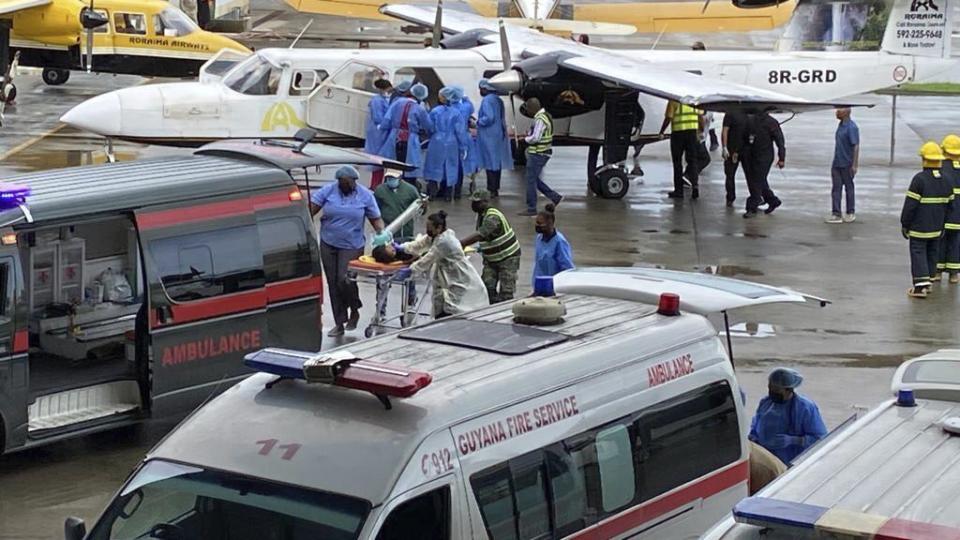 Injured children arrive to the airport in Georgetown, Guyana, Monday, May 22, 2023. A nighttime fire raced through a secondary school dormitory in the town of Mahdia early Monday, killing at least 19 students and injuring several others, authorities said. (AP Photo/Royston Drake)