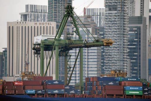 A vessel loaded with cargo containers anchors along the wharf at Keppel port in Singapore in July 2012. Declines in export-driven sectors such as electronics, which are key elements of Singapore's trade-led economy, were the main factors behind the weak second quarter showing, the Ministry of Trade and Industry said