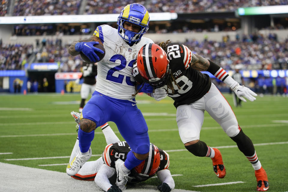 Los Angeles Rams running back Kyren Williams (23) is pushed out of bounds by Cleveland Browns cornerback Mike Ford (28) and linebacker Anthony Walker Jr. (5) during the first half of an NFL football game Sunday, Dec. 3, 2023, in Inglewood, Calif. (AP Photo/Ryan Sun)