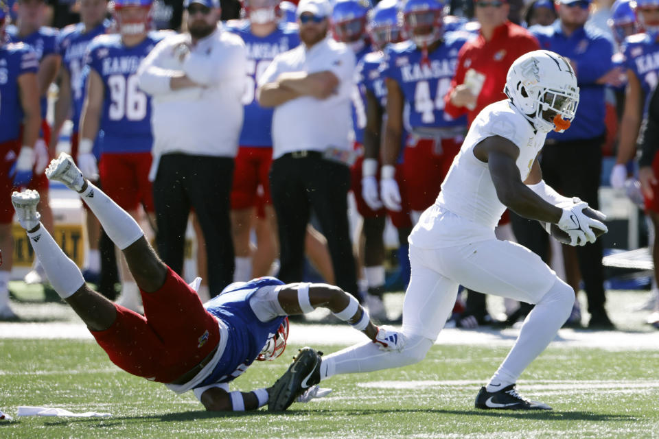 Central Florida wide receiver Javon Baker, right, gets past Kansas safety Marvin Grant, left, after catching a pass for a first down during the first half of an NCAA college football game Saturday, Oct. 7, 2023, in Lawrence, Kan. (AP Photo/Colin E. Braley)