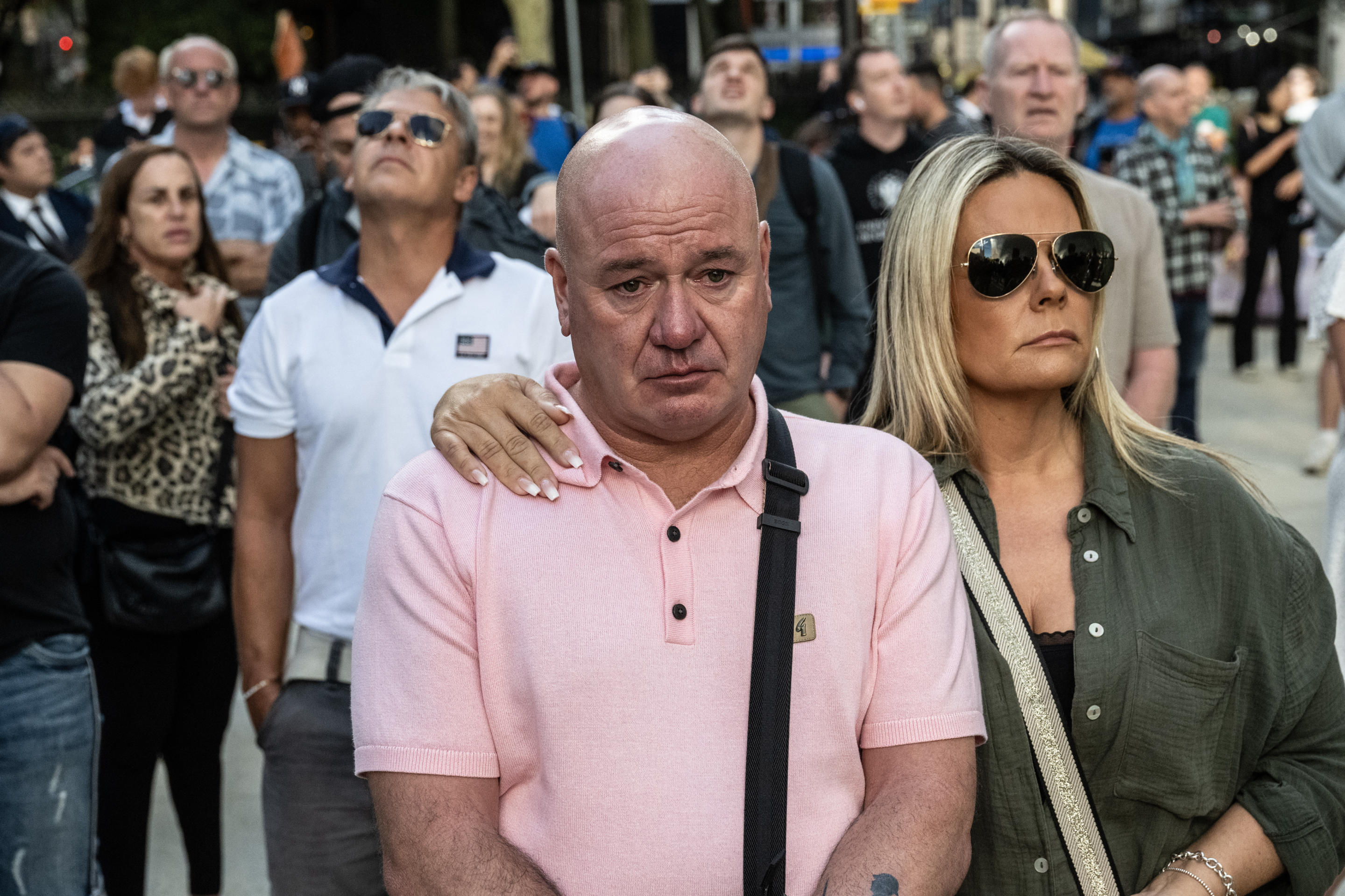 People gather outside the 9/11 memorial on Wednesday for a moment of silence. 