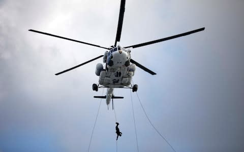 A member of Special Weapon and Tactics (SWAT) rappels down during an anti-terror drill as a part of the Ulchi Freedom Guardian exercise in Goyang - Credit: Reuters