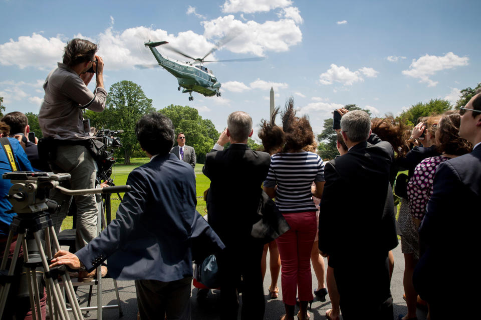 <p>Members of the media and White House staff watch as Marine One, with President Donald Trump aboard, departs from the South Lawn of the White House in Washington, Friday, May 19, 2017, for a short trip to Andrews Air Force Base, Md. (Photo: Andrew Harnik/AP) </p>