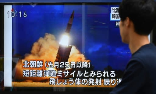 A pedestrian in Tokyo watches a television report on the latest North Korean launch