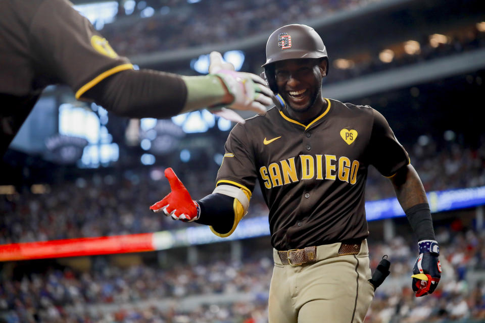 San Diego Padres' Jurickson Profar, right, celebrates hitting a home run with Manny Machado during the sixth inning of a baseball game against the Texas Rangers, Thursday, July 4, 2024, in Arlington, Texas. (AP Photo/Gareth Patterson)