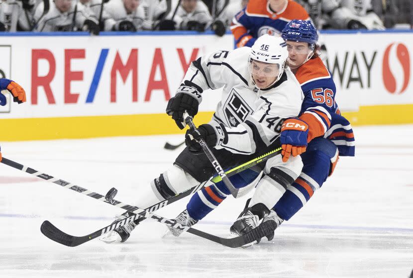 Los Angeles Kings' Blake Lizotte (46) and Edmonton Oilers' Kailer Yamamoto (56) battle for the puck