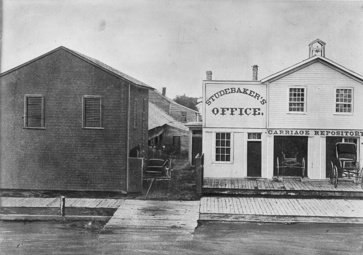 This is how the Studebaker brothers first shop in South Bend looked around 1858. The office and carriage repository at right were added to the original building at left.