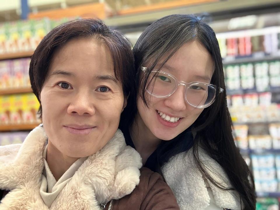 Budding research scientist Nora Sun (right) poses with her mother, Yujie Zhao. Sun, 17, lives part-time with her mother in Jacksonville but attends high school in Chicago.