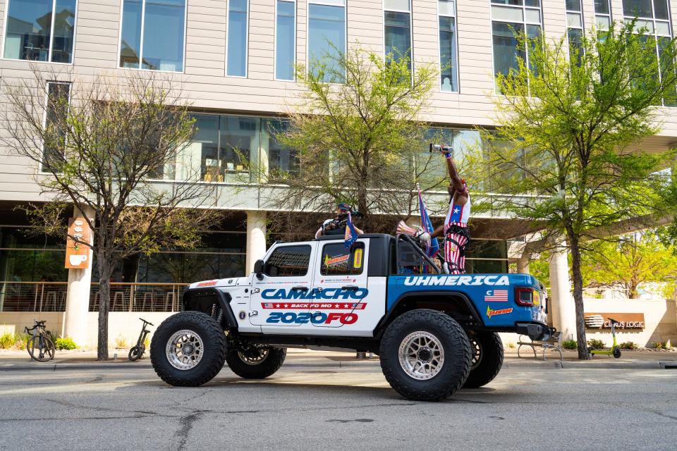 Terry Crews, in character as President Camacho from "Idiocracy," takes off through downtown Saturday on the back of a truck after announcing a presidential run at South by Southwest.