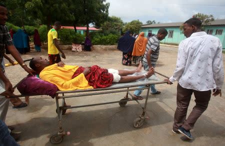 A man injured in a suicide bomb attack at Hotel Nasahablood is wheeled on a stretcher as he arrives to receive treatment at a hospital in Somalia's capital Mogadishu, June 26, 2016. REUTERS/Ismail Taxta