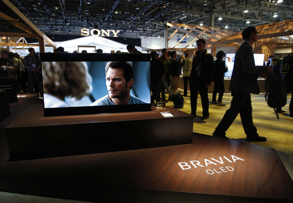 FILE - In this Jan. 8, 2018, file photo, a Sony Bravia OLED television is on display after a Sony news conference at CES International, in Las Vegas. Sony Corp. says its net profit fell 15% in the first half of 2019, though strong sales of entertainment and imaging sensors offset weakness in the games sector. Tokyo-based Sony, which makes Bravia digital TVs and the Aibo robotic dog, upgraded its earnings forecast for the full fiscal year on expectations for stronger sales and lower taxes. (AP Photo/John Locher, File)