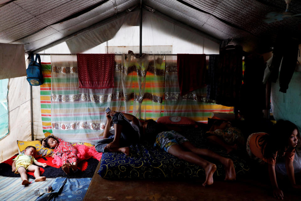 A family takes a nap in a tent at an evacuation camp for families displaced by the Marawi siege, in Marawi City, Lanao del Sur province, Philippines. (Photo: Eloisa Lopez/Reuters)