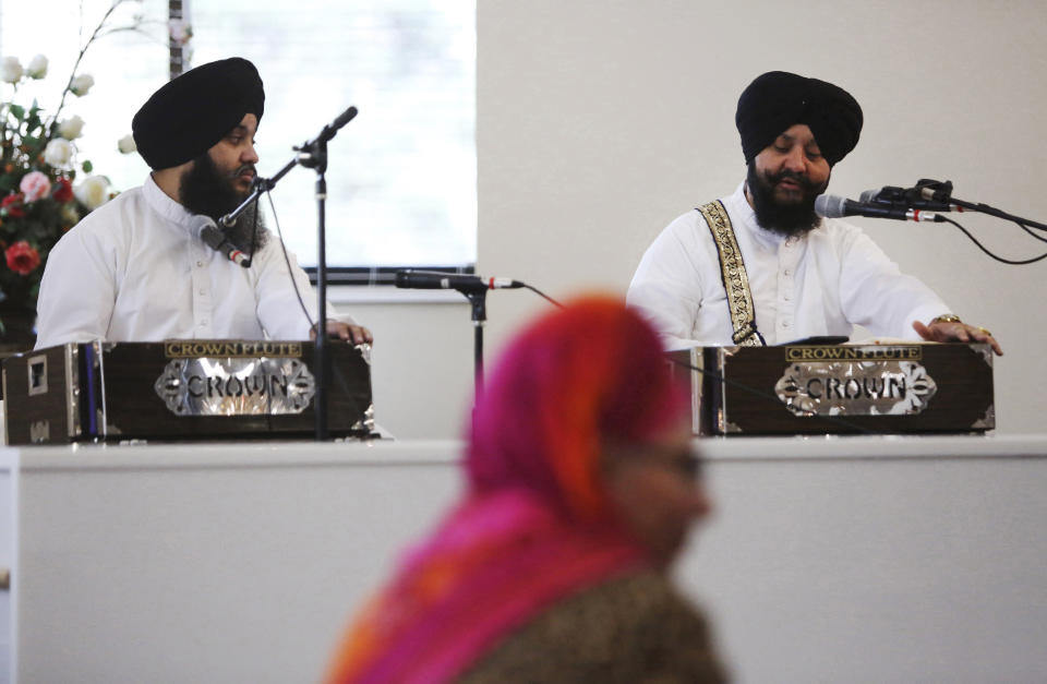 In this April 12, 2020 photo, musicians Dilbagh Singh, left, and Bhai Kuldeep Singh perform during a ceremonial reading from beginning to end of the Guru Granth Sahib, the central sacred book of the Sikh religion, at Guru Nanak Mission in Oakland, New Jersey. Typically the Mission would be preparing to celebrate Vaishakhi, one of the most important holidays in Sikhism, but will conduct the service via a livestream because of the coronavirus pandemic. (AP Photo/Jessie Wardarski)